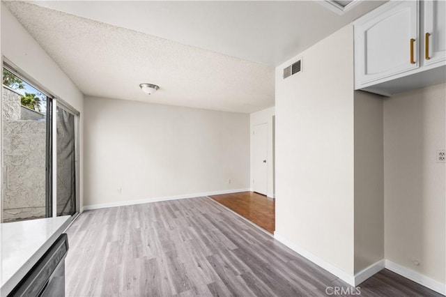 19231 Sherman Way Unit 44, Reseda, CA 91335 - interior space with baseboards, visible vents, light wood-style flooring, and a textured ceiling