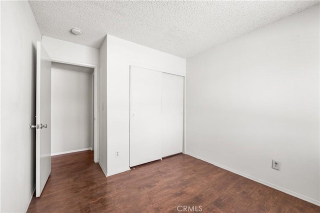 19231 Sherman Way Unit 44, Reseda, CA 91335 - unfurnished bedroom with a closet, wood finished floors, and a textured ceiling