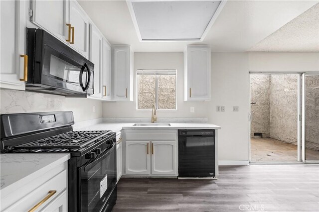 19231 Sherman Way Unit 44, Reseda, CA 91335 - kitchen featuring white cabinetry, light countertops, a sink, and black appliances