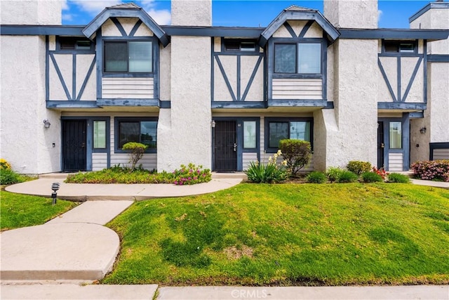 19231 Sherman Way Unit 44, Reseda, CA 91335 - view of front of home with stucco siding, a chimney, and a front lawn