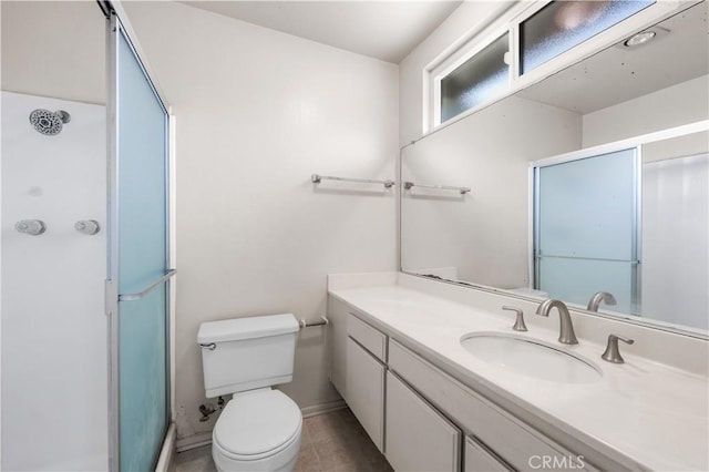 19231 Sherman Way Unit 44, Reseda, CA 91335 - full bath with toilet, vanity, a shower with door, and baseboards