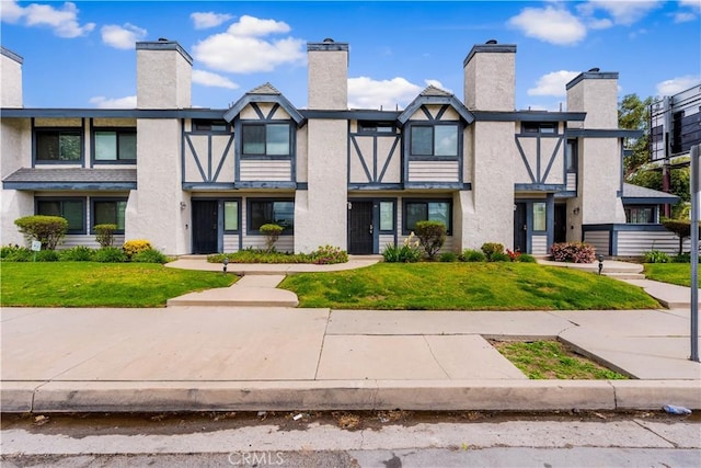 19231 Sherman Way Unit 44, Reseda, CA 91335 - view of front facade featuring a front lawn, a chimney, and stucco siding