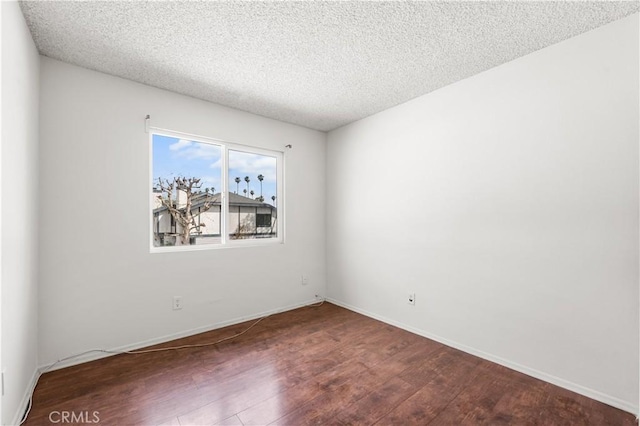 19231 Sherman Way Unit 44, Reseda, CA 91335 - spare room with baseboards, a textured ceiling, and wood finished floors