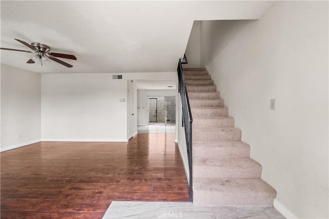 19231 Sherman Way Unit 44, Reseda, CA 91335 - staircase featuring baseboards, a textured ceiling, ceiling fan, visible vents, and wood finished floors