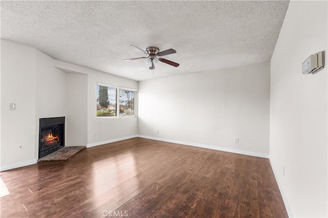 19231 Sherman Way Unit 44, Reseda, CA 91335 - unfurnished living room featuring baseboards, a lit fireplace, a textured ceiling, ceiling fan, and wood finished floors