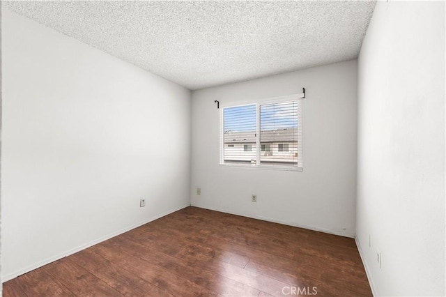 19231 Sherman Way Unit 44, Reseda, CA 91335 - empty room featuring hardwood / wood-style floors, a textured ceiling, and baseboards