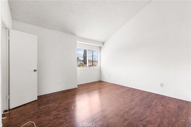 19231 Sherman Way Unit 44, Reseda, CA 91335 - spare room featuring vaulted ceiling, wood finished floors, and a textured ceiling