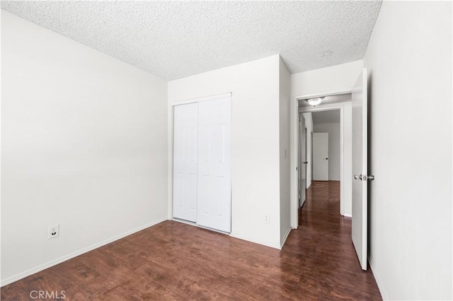 19231 Sherman Way Unit 44, Reseda, CA 91335 - unfurnished bedroom with baseboards, a closet, wood finished floors, and a textured ceiling