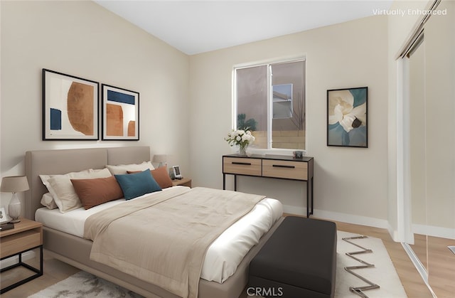 bedroom featuring baseboards and light wood-style flooring