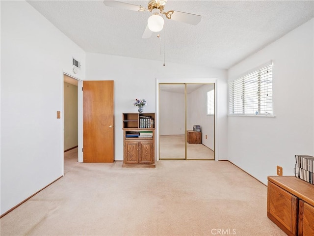 9160 Ox Bow Rd, Lucerne Valley, CA 92356 - interior space with a closet, lofted ceiling, a textured ceiling, and light carpet
