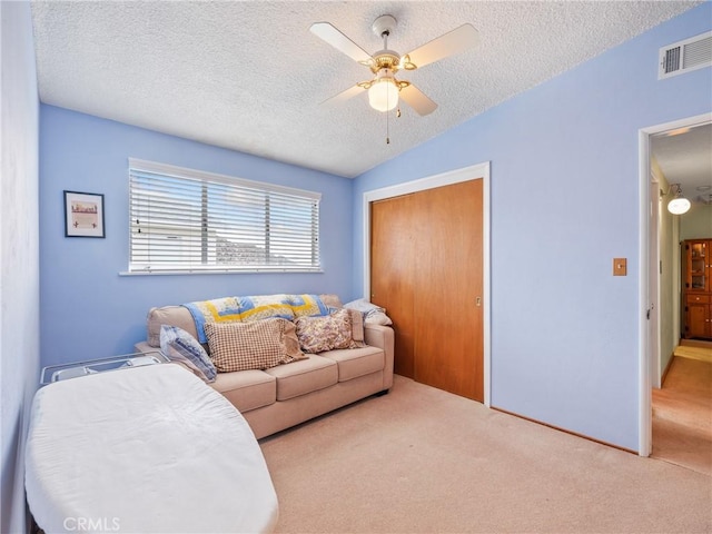 9160 Ox Bow Rd, Lucerne Valley, CA 92356 - living area featuring vaulted ceiling, carpet flooring, a textured ceiling, ceiling fan, and visible vents