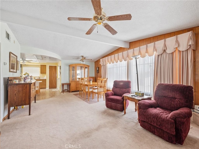 9160 Ox Bow Rd, Lucerne Valley, CA 92356 - living room with a textured ceiling, visible vents, a ceiling fan, light carpet, and vaulted ceiling with beams