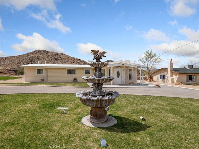 9160 Ox Bow Rd, Lucerne Valley, CA 92356 - back of house with a mountain view and a yard