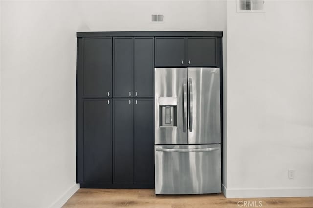 kitchen with visible vents, baseboards, light wood finished floors, and stainless steel refrigerator with ice dispenser