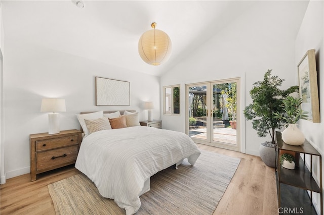 bedroom with access to exterior, high vaulted ceiling, light wood-style floors, and baseboards