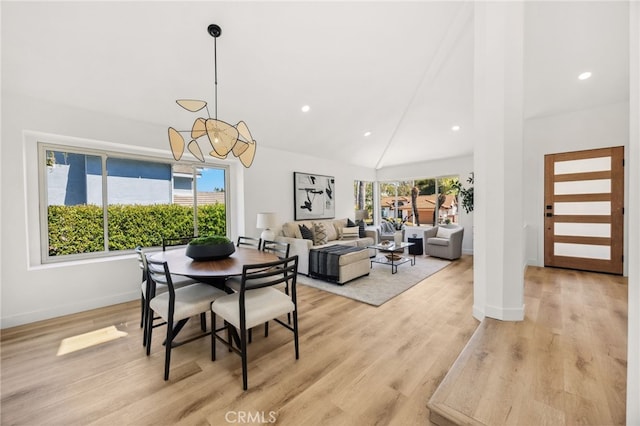 dining area featuring high vaulted ceiling, recessed lighting, light wood-type flooring, and baseboards
