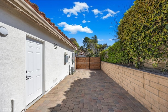 view of home's exterior featuring a patio area, fence, crawl space, and stucco siding
