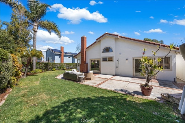rear view of property featuring an outdoor living space, a tiled roof, a yard, stucco siding, and a patio area