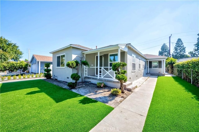 bungalow-style house featuring stucco siding, fence, a front lawn, a sunroom, and crawl space