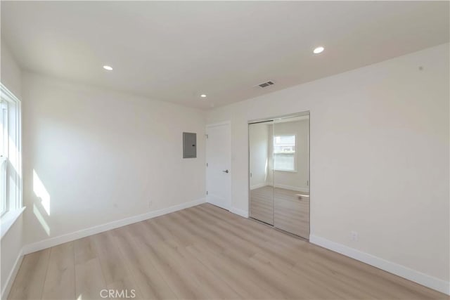 unfurnished bedroom featuring recessed lighting, baseboards, light wood-style floors, and visible vents