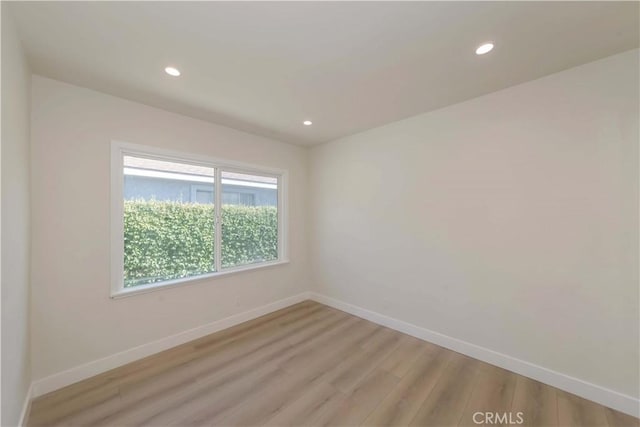 unfurnished room featuring baseboards, recessed lighting, and light wood-type flooring