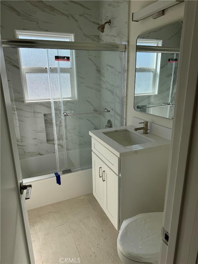 bathroom with enclosed tub / shower combo and vanity