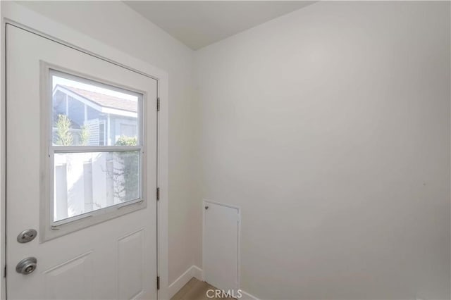 doorway to outside with baseboards