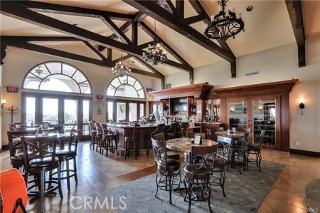 dining space with french doors, beamed ceiling, high vaulted ceiling, and an inviting chandelier
