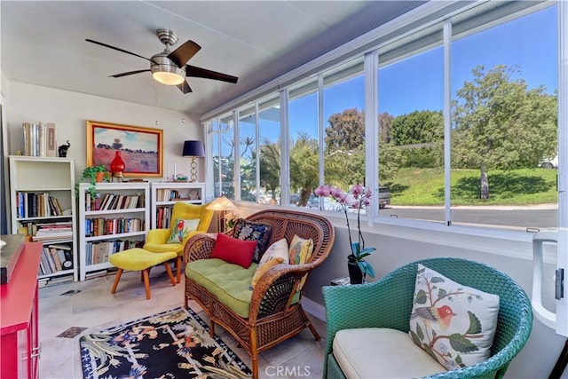 sitting room featuring tile patterned floors and ceiling fan