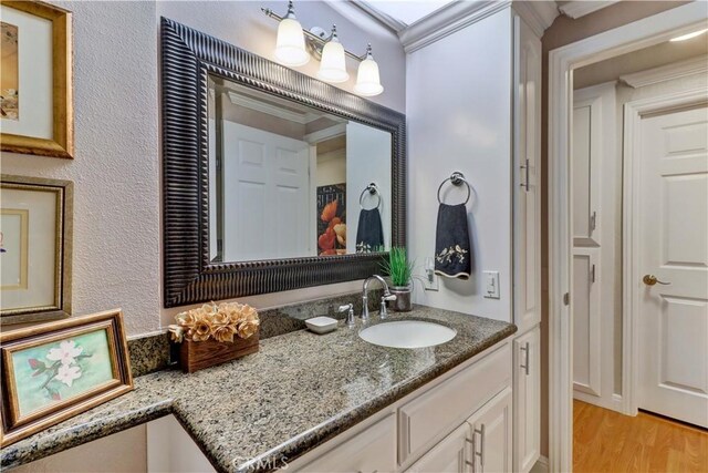 bathroom featuring vanity and wood finished floors