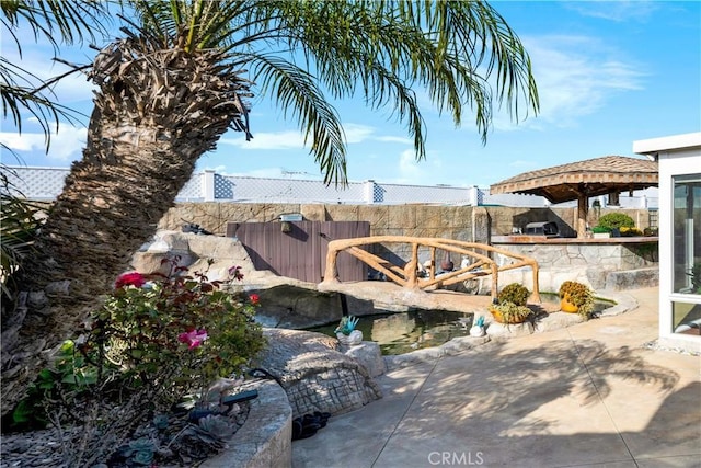 view of yard with fence and a patio
