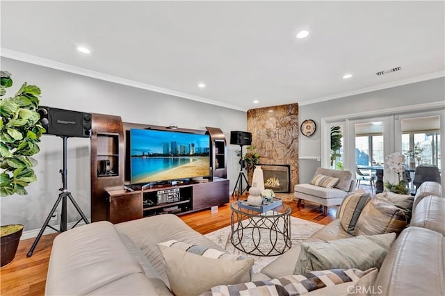 living area with visible vents, crown molding, light wood-style flooring, and recessed lighting