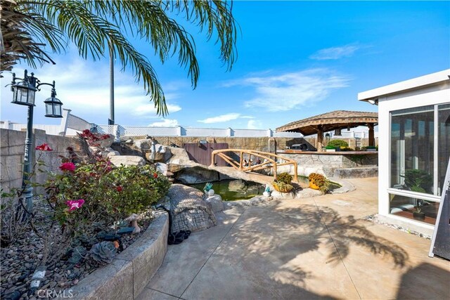 view of patio / terrace with a fenced backyard and a gazebo