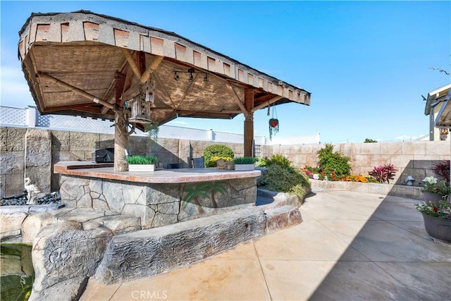 view of patio featuring a fenced backyard and a gazebo