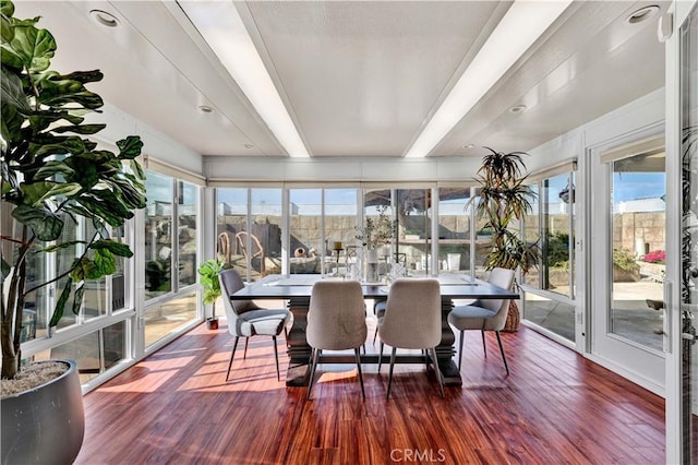 sunroom featuring a wealth of natural light and wood finished floors