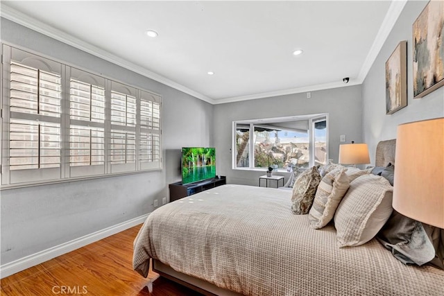 bedroom featuring baseboards, ornamental molding, wood finished floors, and recessed lighting