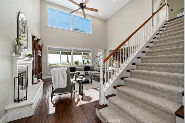 38925 Cherry Point Ln, Murrieta, CA 92563 - stairway featuring ceiling fan, a healthy amount of sunlight, hardwood / wood-style flooring, and a high ceiling