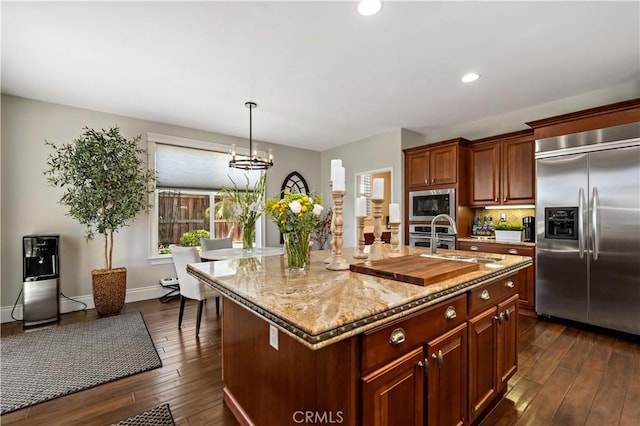 38925 Cherry Point Ln, Murrieta, CA 92563 - kitchen featuring dark wood-type flooring, light stone countertops, a sink, and built in appliances