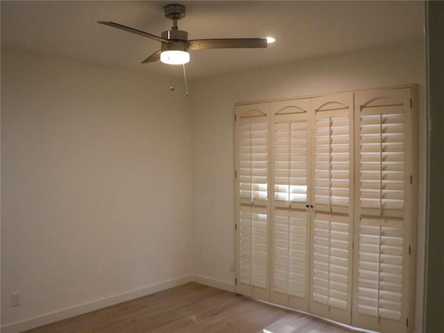 spare room featuring ceiling fan, baseboards, wood finished floors, and recessed lighting