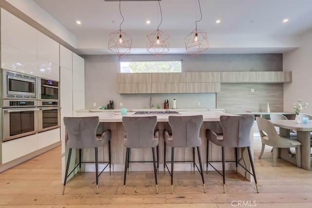 737 N Cherokee Ave, Los Angeles, CA 90038 - kitchen with backsplash, modern cabinets, and appliances with stainless steel finishes