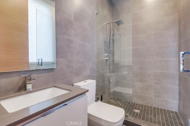 737 N Cherokee Ave, Los Angeles, CA 90038 - bathroom with tile walls, a tile shower, toilet, and vanity