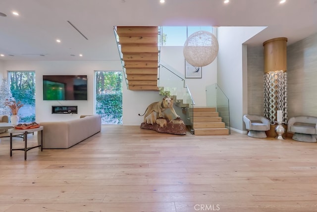 737 N Cherokee Ave, Los Angeles, CA 90038 - living area featuring stairs, wood finished floors, a healthy amount of sunlight, and recessed lighting