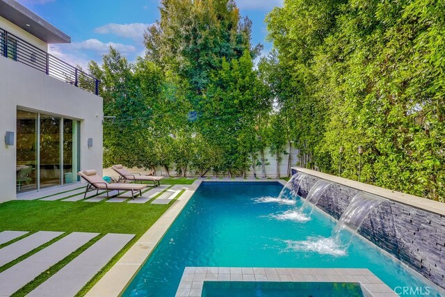 737 N Cherokee Ave, Los Angeles, CA 90038 - pool featuring a fenced backyard, a lawn, and a patio