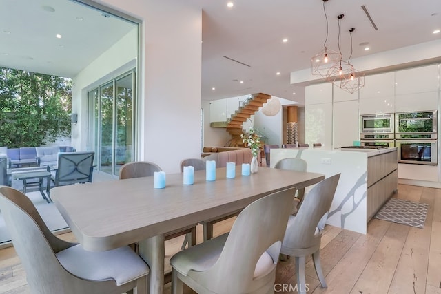 737 N Cherokee Ave, Los Angeles, CA 90038 - dining room with stairs, light wood-type flooring, and recessed lighting