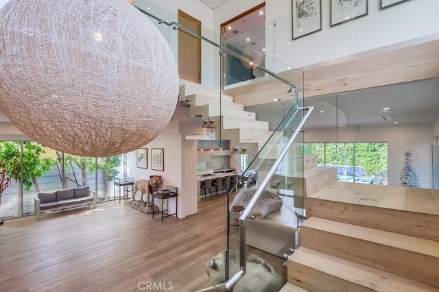 737 N Cherokee Ave, Los Angeles, CA 90038 - staircase featuring a wealth of natural light, a high ceiling, and wood finished floors