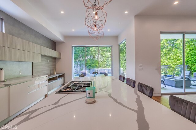 737 N Cherokee Ave, Los Angeles, CA 90038 - kitchen with stainless steel gas cooktop, recessed lighting, and light stone counters