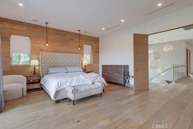 737 N Cherokee Ave, Los Angeles, CA 90038 - bedroom featuring recessed lighting, multiple windows, wood walls, and light wood-style floors