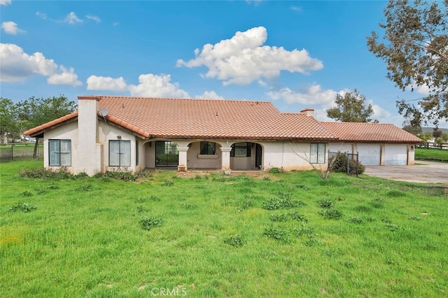 view of front of property featuring stucco siding, a chimney, a tiled roof, and concrete driveway