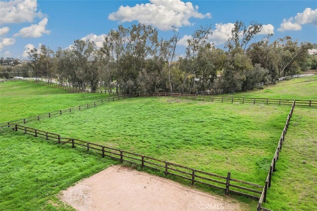 view of yard featuring a rural view and fence