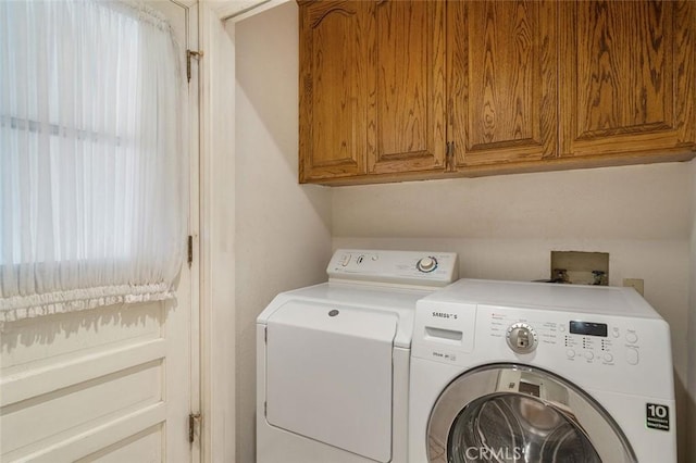 laundry area featuring cabinet space and washing machine and clothes dryer
